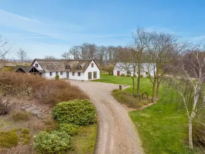 a dirt road leading to a white house at Holiday Home Åsta - 400m to the fjord by Interhome in Roslev