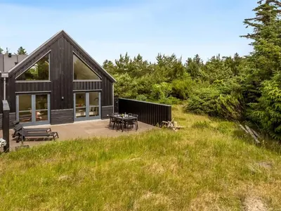 a house on a hill with a patio at Holiday Home Anelle - 2-5km from the sea by Interhome in Blokhus