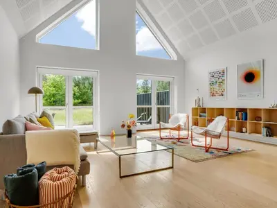 a living room with a couch and two chairs at Holiday Home Anelle - 2-5km from the sea by Interhome in Blokhus