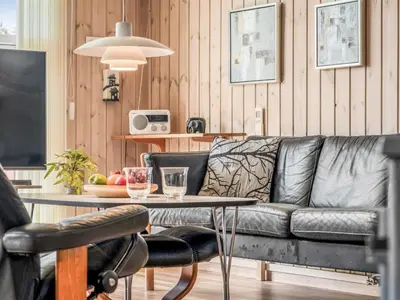 a living room with a couch and a table at Holiday Home Hans - 1-2km from the sea by Interhome in Løkken