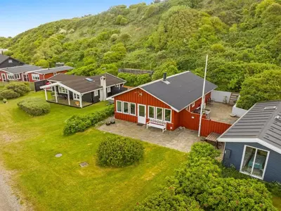 an aerial view of a house with a mountain in the background at Holiday Home Blia - 120m to the fjord by Interhome in Løgstør
