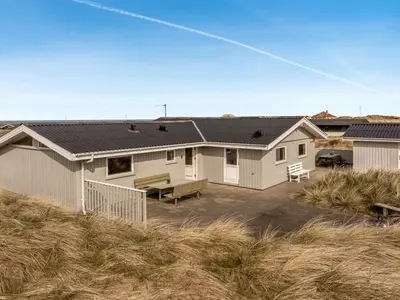 a house with a solar roof on a beach at Holiday Home Fridgerd - 300m from the sea by Interhome in Løkken