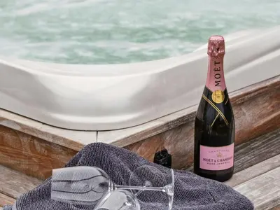 a bottle of champagne next to a pair of glasses at Holiday Home Sinika - 100m from the sea by Interhome in Blokhus