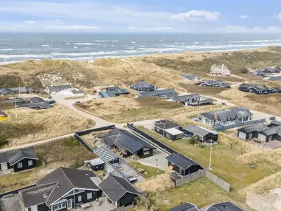 an aerial view of houses on the beach at Holiday Home Sinika - 100m from the sea by Interhome in Blokhus