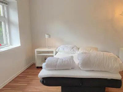 a bed with four pillows on it in a room at Holiday Home Elza - 2-5km from the sea by Interhome in Fjerritslev
