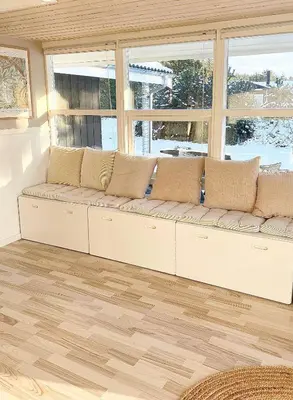 a white couch in a room with windows at Beautiful Home Near Løkken On Secluded Plot in Løkken
