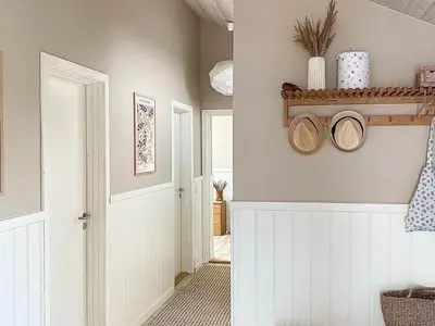 a hallway with a white door and a shelf with plates at Beautiful Home Near Løkken On Secluded Plot in Løkken