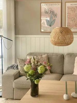 a living room with a couch and a vase of flowers on a table at Beautiful Home Near Løkken On Secluded Plot in Løkken