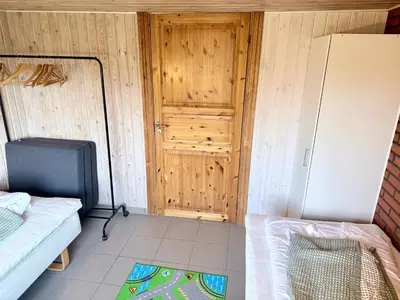 a small room with a refrigerator and a tv at Amtoft Vig Kitespot in Vesløs