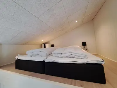 a large bed in a room with a ceiling at Motel Glyngøre in Roslev