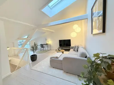 a living room with a couch and a tv at Cozy Pearl in Viborg Centre in Viborg