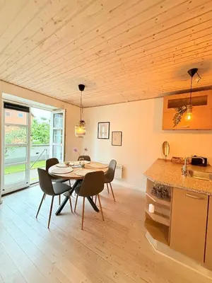 a kitchen and dining room with a table and chairs at Cozy Pearl in Viborg Centre in Viborg
