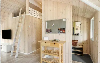 a tiny house with a ladder and a desk at 4 Bedroom Stunning Home In Fjerritslev in Fjerritslev