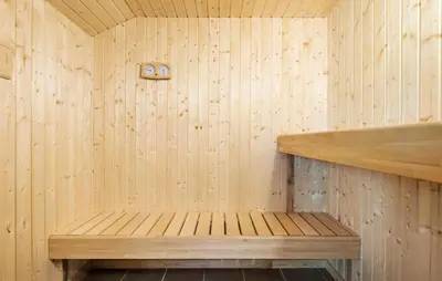a wooden sauna with a wooden bench in it at 4 Bedroom Stunning Home In Fjerritslev in Fjerritslev