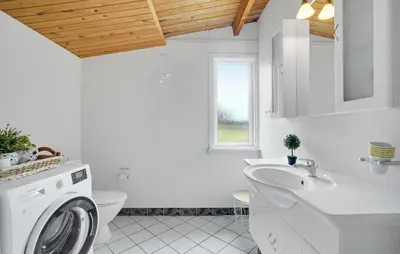 a white bathroom with a washing machine in it at Pet Friendly Home In Thisted With Wifi in Thisted