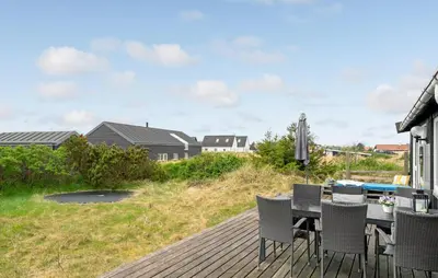 a deck with a table and chairs on a house at Pet Friendly Home In Thisted With Wifi in Thisted