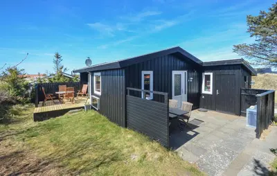 a black shipping container house with a patio at 2 Bedroom Pet Friendly Home In Thisted in Thisted