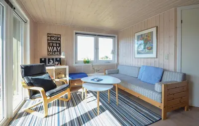 a living room with a couch and a table at 2 Bedroom Pet Friendly Home In Thisted in Thisted
