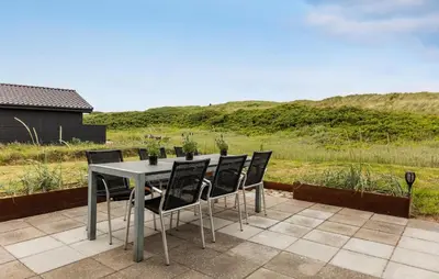 a table and chairs sitting on top of a patio at 3 Bedroom Nice Home In Harboøre in Harboør