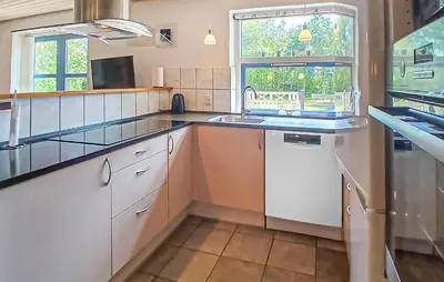 a kitchen with white cabinets and a sink and a window at Beautiful Home In Højslev With Sauna in Højslev