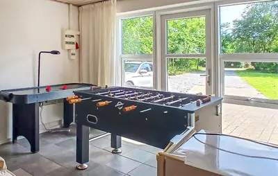a ping pong table in a room with windows at Beautiful Home In Højslev With Sauna in Højslev
