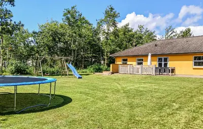 a yard with a slide and a playground at Beautiful Home In Højslev With Sauna in Højslev