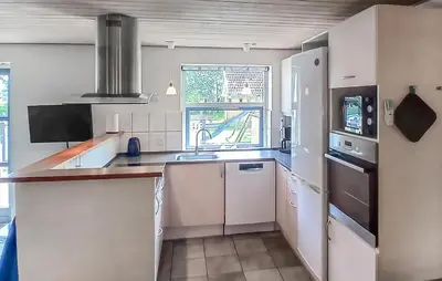 a kitchen with white cabinets and a sink and a window at Beautiful Home In Højslev With Sauna in Højslev