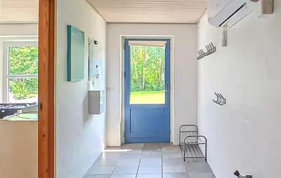 a hallway with a blue door in a room at Beautiful Home In Højslev With Sauna in Højslev