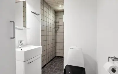 a white bathroom with a toilet and a sink at Awesome Home In Løgstør With Wifi in Løgstør