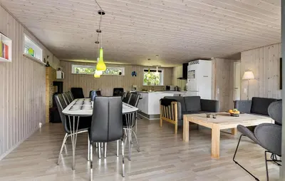 a kitchen and living room with a table and chairs at Awesome Home In Løgstør With Wifi in Løgstør