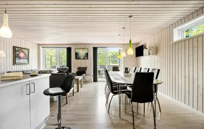 a kitchen and dining room with a table and chairs at Awesome Home In Løgstør With Wifi in Løgstør
