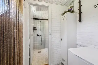 a white bathroom with a shower and a sink at Astrup Vig Hideaway, Thatched Cottage with Shelter & Serenity in Roslev