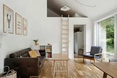 a living room with a couch and a table at Architect-Designed Wooden House At Ertebølle in Farsø