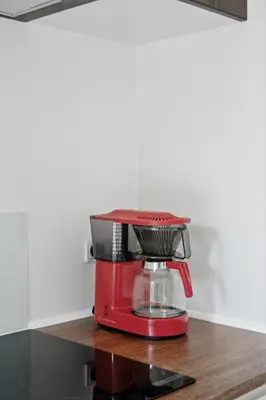 a red blender sitting on top of a counter at Architect-Designed Wooden House At Ertebølle in Farsø