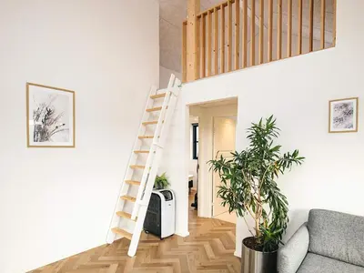 a staircase in a living room with a couch at 5 star holiday home in Løkken in Løkken