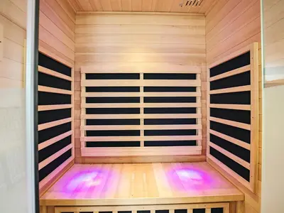 a sauna with wood paneling and purple lighting at 5 star holiday home in Løkken in Løkken
