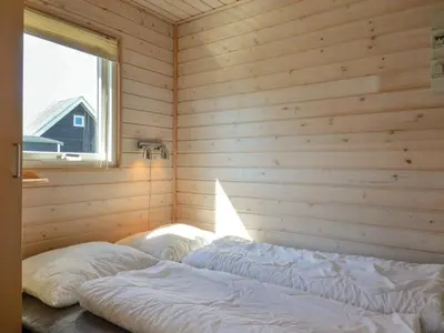a room with two beds in a wooden room at 4 star holiday home in Thyborøn in Thyborøn