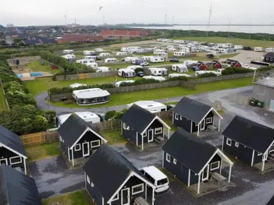 an aerial view of a parking lot with houses and cars at 4 star holiday home in Thyborøn in Thyborøn