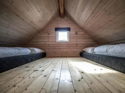 a room with two beds in a wooden house at 4 star holiday home in Thyborøn in Thyborøn