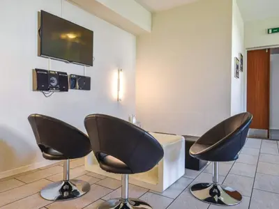 a waiting room with two chairs and a flat screen tv at 4 star holiday home in Thyborøn in Thyborøn