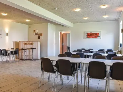 a room with rows of tables and chairs at 4 star holiday home in Thyborøn in Thyborøn
