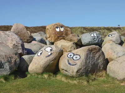 a group of rocks with faces painted on them at 5 star holiday home in Thyborøn in Thyborøn