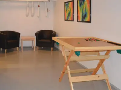 a ping pong table in a room with two chairs at 5 star holiday home in Thyborøn in Thyborøn