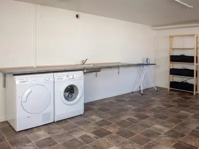 a laundry room with a washing machine and a counter at 5 star holiday home in Thyborøn in Thyborøn