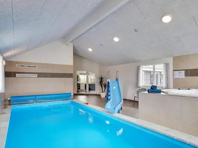 a swimming pool with a slide in a room at 5 star holiday home in Spøttrup in Spottrup