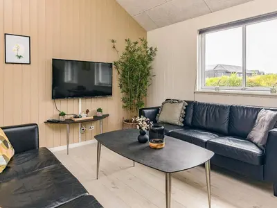 a living room with a couch and a table at 5 star holiday home in Spøttrup in Spottrup