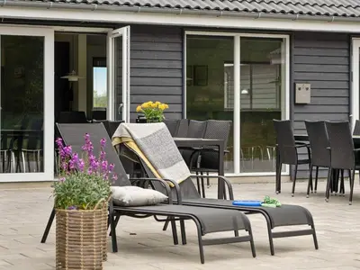 a group of chairs and tables on a patio at 5 star holiday home in Spøttrup in Spottrup