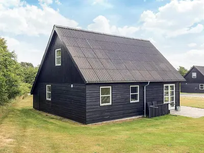 a black house with a metal roof at 5 star holiday home in Farsø in Farsø