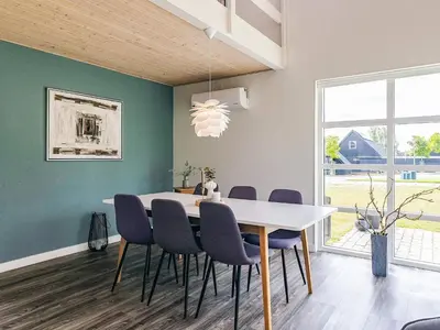 a dining room with a white table and chairs at 5 star holiday home in Farsø in Farsø