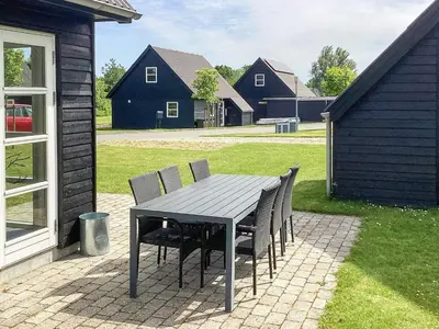 a table and chairs sitting on a brick patio at 5 star holiday home in Farsø in Farsø